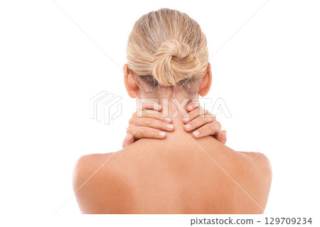 Neck pain, injury and woman in a studio with discomfort, stress or ache after a spa body care treatment. Self care, sore and back view of a female model with a muscle sprain by a white background. 129709234
