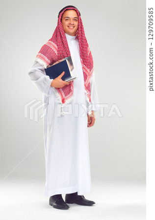 Portrait, Islamic man and books for education, knowledge and guy isolated on white studio background. Muslim, male and student with journals, smile and confident for studying, learning and university Portrait, Islamic man and books for education, knowledge and guy isolated on white studio background. Muslim, male and student with journals, smile and confident for studying, learning and university 129709585