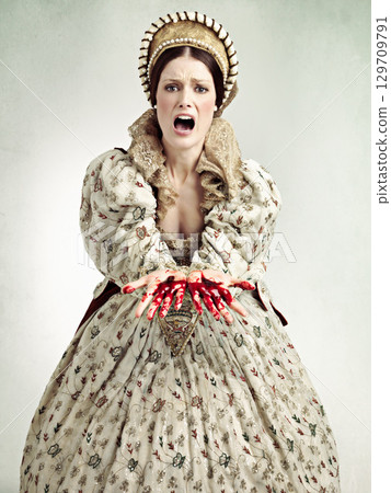 Queen woman, blood hands and studio with screaming, emergency and crime with ancient royal fashion. Medieval leader, crying and evil with shock, surprise and danger in renaissance clothes for murder 129709791