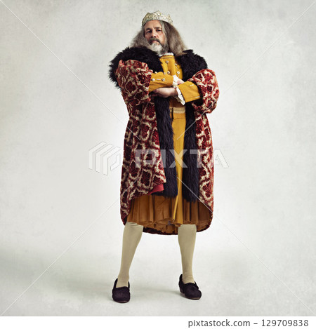 King, royalty and portrait of man in studio isolated on a gray background mock up. Retro victorian, vintage crown and leadership of mature, proud and confident male regal ruler with arms crossed. 129709838