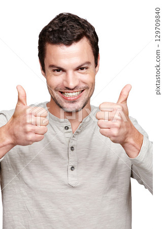 Young man, thumbs up and smile for winning, discount or sale against a white studio background. Portrait of a isolated handsome male giving thumbsup for agreement, yes or approval on white background 129709840