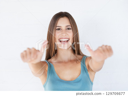 Portrait, young woman and thumbs up with smile, celebration and girl isolated on white studio background. Female, lady and gesture for agreement, happiness or winner with success, relax or motivation Portrait, young woman and thumbs up with smile, celebration and girl isolated on white studio background. Female, lady and gesture for agreement, happiness or winner with success, relax or motivation 129709877