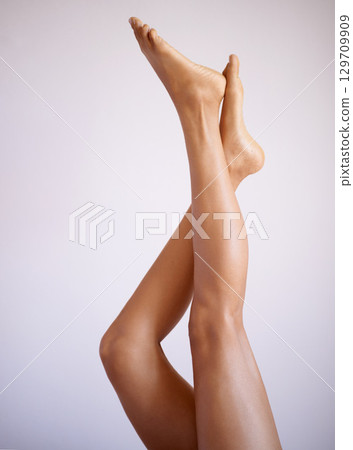 Legs, beauty and skin with a model black woman posing in studio on a gray background for skincare treatment. Fitness, spa and feet with a female isolated indoors for natural care or luxury wellness Legs, beauty and skin with a model black woman posing in studio on a gray background for skincare treatment. Fitness, spa and feet with a female isolated indoors for natural care or luxury wellness 129709909