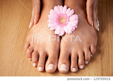 Natural woman and manicure with flower on feet for luxury cosmetic treatment with spa pedicure nails zoom. Healthy skincare of black woman with daisy for beauty, wellness and pamper lifestyle. 129709918