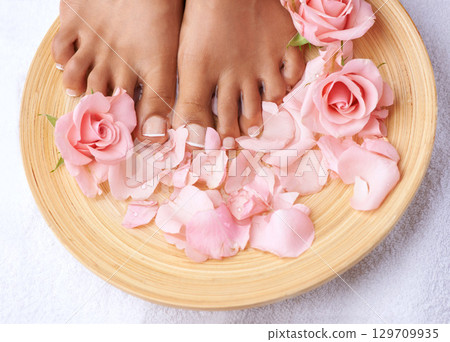 Pedicure, beauty and feet of a woman with flowers for cleaning, treatment and detox. Spa, dermatology and above foot of a model with a floral, cosmetic and natural grooming with roses for luxury Pedicure, beauty and feet of a woman with flowers for cleaning, treatment and detox. Spa, dermatology and above foot of a model with a floral, cosmetic and natural grooming with roses for luxury 129709935