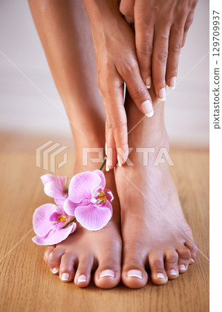 Spa girl and flower feet with hands on skin for luxury cosmetic treatment with manicure and pedicure nails. Healthy skincare of black woman with orchid for beauty, wellness and pamper lifestyle. Spa girl and flower feet with hands on skin for luxury cosmetic treatment with manicure and pedicure nails. Healthy skincare of black woman with orchid for beauty, wellness and pamper lifestyle. 129709937