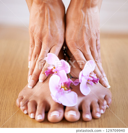 Skincare girl and hands with flowers on feet for luxury cosmetic treatment with manicure and pedicure nails. Healthy skin of black woman with orchid for beauty, wellness and pamper lifestyle. 129709940
