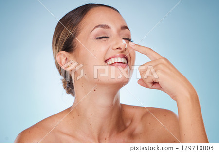 Skincare, cream and woman with natural care, organic facial or smooth skin on blue studio background. Female, girl and lotion for beauty, cosmetics and wellness for dermatology, smile or makeup creme 129710003