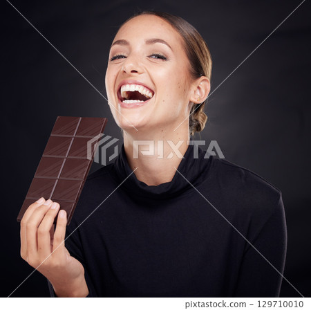 Chocolate, diet and beauty with woman and skincare with healthy candy, luxury and wellness with food and portrait. Happy female with calories, cosmetic and cacao with skin with studio background 129710010