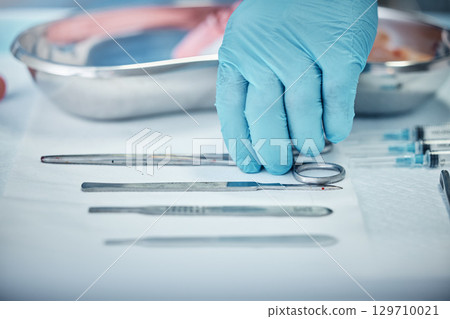 Surgery, tools and doctor hand with health, glove for safety and protection with medical equipment zoom. Surgeon, organize and cardiology healthcare, ready for cardiovascular surgical procedure. Surgery, tools and doctor hand with health, glove for safety and protection with medical equipment zoom. Surgeon, organize and cardiology healthcare, ready for cardiovascular surgical procedure. 129710021