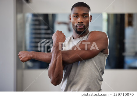 Gym portrait and black man stretching arms for bodybuilder fitness and muscle warm up with focus. Training, wellness and athlete man workout preparation for exercise lifestyle at health club. 129710070