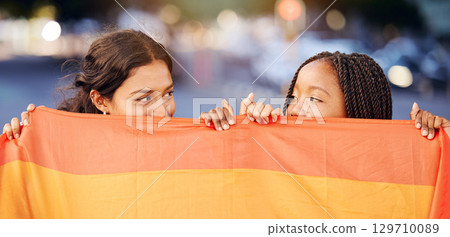Rainbow flag, LGBTQ and happy lesbian couple with love at a freedom, pride or community parade in the city. Celebration, interracial and gay women with commitment at a LGBT sexuality event in town. 129710089