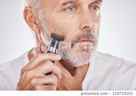 Senior man, shaving facial hair and grooming beard for skincare, hygiene and wellness with dermatolgy cosmetics. Hair removal, epilation and beauty of elderly male cleaning face on studio background Senior man, shaving facial hair and grooming beard for skincare, hygiene and wellness with dermatolgy cosmetics. Hair removal, epilation and beauty of elderly male cleaning face on studio background 129710103