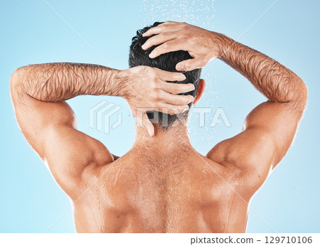Water splash, man back and hair care shower for body hygiene, skincare grooming or cleaning care in blue background studio. Model, self care water cleansing and cosmetics wellness for morning routine 129710106