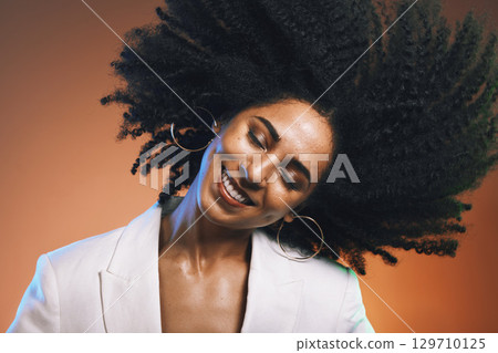 Hair, afro and black woman, beauty with smile on face and cosmetic and hair care with happiness against studio background. Dance, natural curly hair texture and makeup with earrings and freedom 129710125