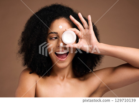 Cream container, skincare and black woman in studio happy for facial product, natural cosmetics or beauty mockup. African model with wow face for serum, collagen or dermatology sunscreen in her hand Cream container, skincare and black woman in studio happy for facial product, natural cosmetics or beauty mockup. African model with wow face for serum, collagen or dermatology sunscreen in her hand 129710139
