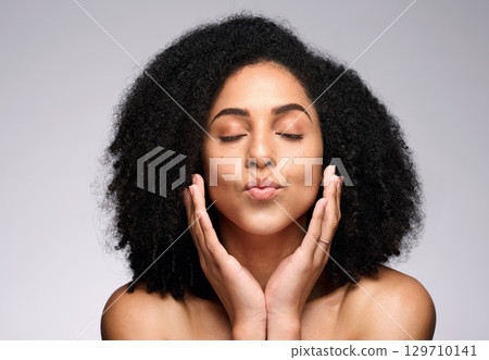 Face kiss, skincare beauty and black woman with eyes closed in studio isolated on a gray background. Natural cosmetics, makeup and young female model pouting lips satisfied with spa facial treatment. Face kiss, skincare beauty and black woman with eyes closed in studio isolated on a gray background. Natural cosmetics, makeup and young female model pouting lips satisfied with spa facial treatment. 129710141