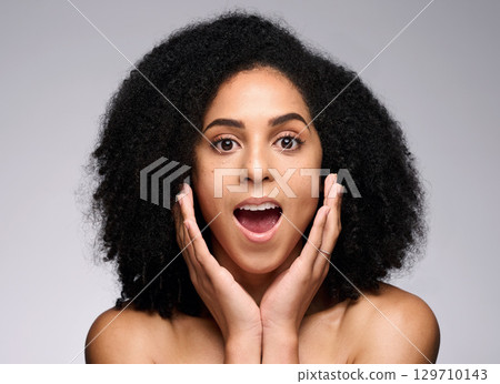 Face skincare, wow and surprised black woman in studio isolated on gray background. Makeup cosmetics, portrait and female model shocked after spa facial treatment for healthy skin, beauty or wellness 129710143