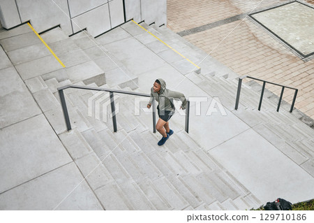 Running, stairs and city with a sports black man from above for a cardio or endurance workout for fitness. Training, exercise or motivation with a male runner or athlete moving up an urban staircase Running, stairs and city with a sports black man from above for a cardio or endurance workout for fitness. Training, exercise or motivation with a male runner or athlete moving up an urban staircase 129710186