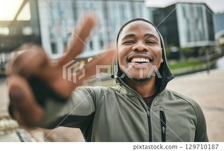 Fitness, selfie and portrait of a black man with peace sign in the city doing a cardio exercise. Happy, smile and real African guy taking picture while running for sports, race or marathon training. Fitness, selfie and portrait of a black man with peace sign in the city doing a cardio exercise. Happy, smile and real African guy taking picture while running for sports, race or marathon training. 129710187