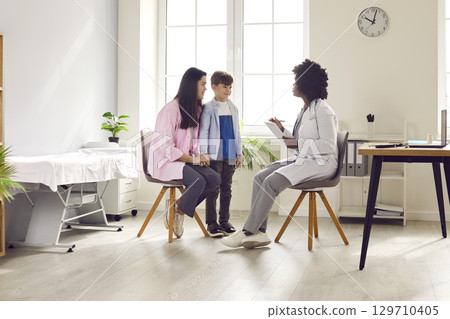 Cute boy and his mom visiting doctor in medical clinic 129710405