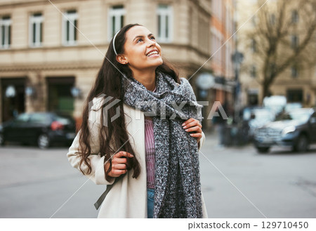 Walking, city buildings and happy woman on outdoor travel adventure in sidewalk street, road or journey In Chicago Illinois. Urban architecture, beauty and girl smile on winter vacation tour in USA 129710450