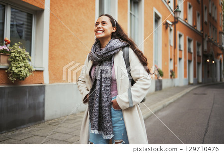 Excited, travel and walking woman in the city street for adventure, exploring and smile at architecture in France. Thinking, happy and girl on a walk in the road with an idea during a holiday 129710476