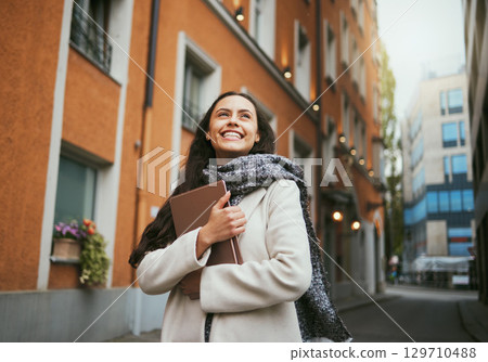 Travel, tourist and book with a sightseeing woman in the city traveling for tourism or vacation. Thinking, journal and traveling with a young female overseas or abroad for holiday in an urban town 129710488
