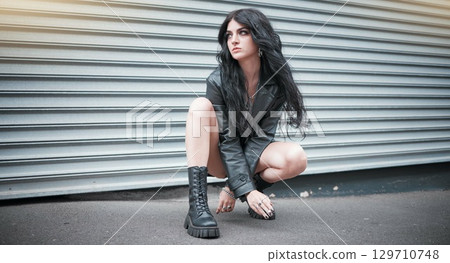 Young woman, fashion and streetwear with gen z punk style, outdoor and trendy, edgy and stylish in urban city. Youth, focus and beauty with rock aesthetic, fashion model in designer clothes in London Young woman, fashion and streetwear with gen z punk style, outdoor and trendy, edgy and stylish in urban city. Youth, focus and beauty with rock aesthetic, fashion model in designer clothes in London 129710748