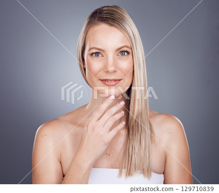 Woman, hair wellness and beauty portrait for salon growth, luxury cosmetics care and dermatology keratin treatment in grey studio background. Model face, skincare glow motivation and hair care shine 129710839