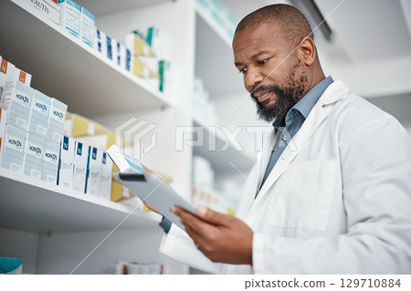 Pharmacy, medicine and black man with tablet to check inventory, stock and medication for online prescription. Healthcare, medical worker and pharmacist with pills, health products and checklist 129710884