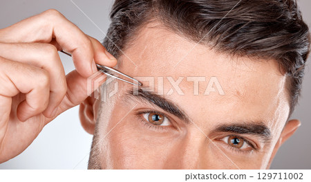 Man, eyebrow tweezers and eyes portrait for hair removal, skincare beauty and grooming wellness or hygiene cleaning in grey studio background. Model, cosmetics facial care and brows microblading 129711002