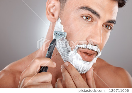 Grooming, foam and shaving with face of man with razor for beauty, hygiene and skincare with morning routine. Self care, facial and shave beard with model and cream product for wellness and cleaning Grooming, foam and shaving with face of man with razor for beauty, hygiene and skincare with morning routine. Self care, facial and shave beard with model and cream product for wellness and cleaning 129711006