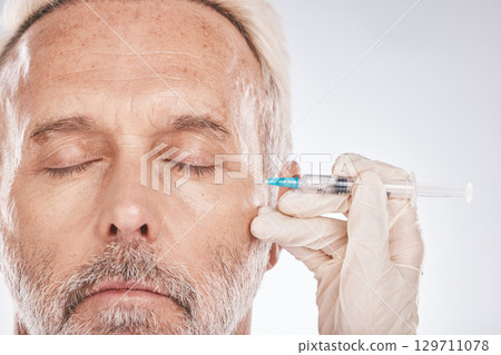 Man face, hands or cosmetic surgery needle on studio background for skincare collagen, medical dermatology or anti aging grooming. Zoom, plastic surgeon or mature patient injection for facial change Man face, hands or cosmetic surgery needle on studio background for skincare collagen, medical dermatology or anti aging grooming. Zoom, plastic surgeon or mature patient injection for facial change 129711078
