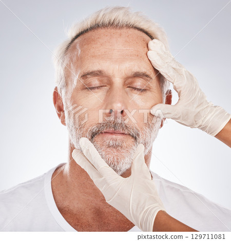 Man, face or plastic surgeon hands on studio background for skincare collagen, medical help dermatology or anti aging grooming. Zoom, cosmetic surgery or mature patient model in facial change consult 129711081