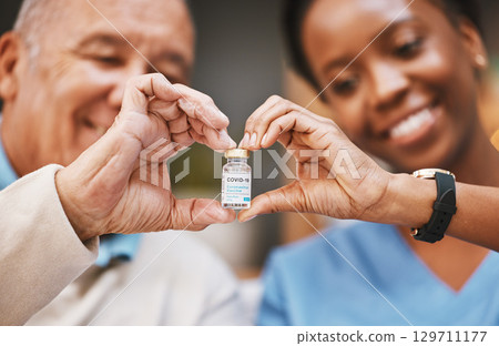 Corona virus vaccine, heart hands and people with vial in nursing home in support of medical innovation, medicine product or bottle. Covid 19 vaccination, healthcare and finger shape of patient trust Corona virus vaccine, heart hands and people with vial in nursing home in support of medical innovation, medicine product or bottle. Covid 19 vaccination, healthcare and finger shape of patient trust 129711177