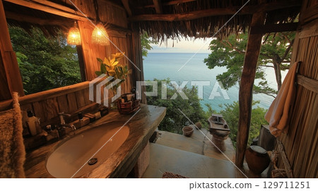 Rustic tropical bathroom with bathtub overlooking the ocean 129711251