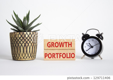 Growth Portfolio symbol. Concept word Growth Portfolio on wooden blocks. Beautiful white background with alarm clock and succulent plant. Business and Growth Portfolio concept. Copy space Growth Portfolio symbol. Concept word Growth Portfolio on wooden blocks. Beautiful white background with alarm clock and succulent plant. Business and Growth Portfolio concept. Copy space 129711406