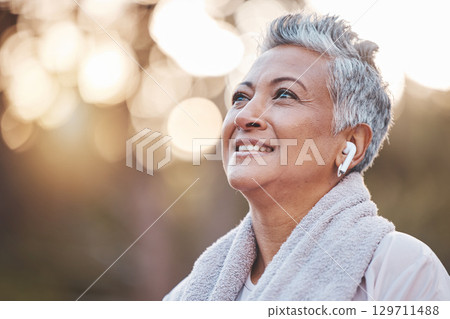 Fitness, exercise and senior woman listening to music in nature with earphones for running , thinking and wellness. Face of an elderly female outdoor to run for a healthy lifestyle, body and energy 129711488