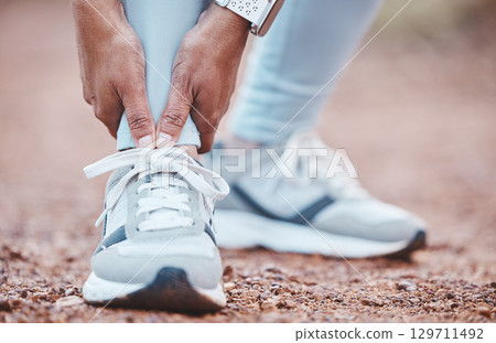 Foot injury, fitness accident and woman in nature with a body emergency, training pain and arthritis. Muscle problem, inflammation and feet of a runner with an injured ankle during outdoor cardio 129711492