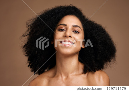 Black woman, portrait and happiness for skincare wellness, natural curly hair care and cosmetics dermatology in brown background studio. African girl, smile and luxury self care beauty or body glow 129711579