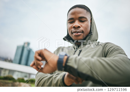 Time, watch and black man running in city for fitness motivation, training goal and heart performance in Nigeria. Monitor, exercise and African runner with a smart watch for reading health progress 129711596