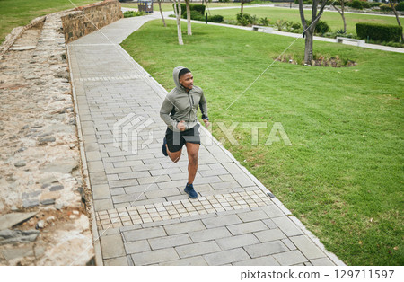 Fitness, running and black man runner outdoor in park for body workout and exercise, cardio and energy. Marathon training, run and sport motivation with wellness, healthy and active in Washington DC 129711597
