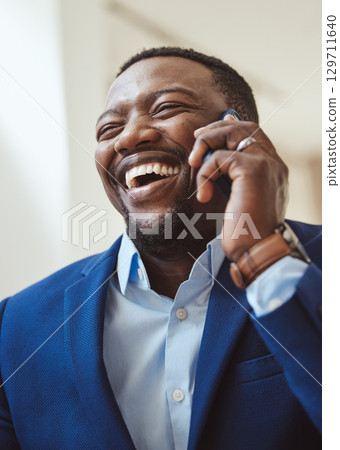 Phone call, communication and laughing with a business black man talking while working in corporate. Mobile, networking or management with a male CEO feeling happy while chatting on his smartphone Phone call, communication and laughing with a business black man talking while working in corporate. Mobile, networking or management with a male CEO feeling happy while chatting on his smartphone 129711640