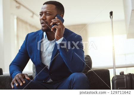 African man in hotel, on business call and listening to voice message in Chicago for work travel. Corporate professional, young black entrepreneur talking on smartphone and luxury airport building African man in hotel, on business call and listening to voice message in Chicago for work travel. Corporate professional, young black entrepreneur talking on smartphone and luxury airport building 129711642