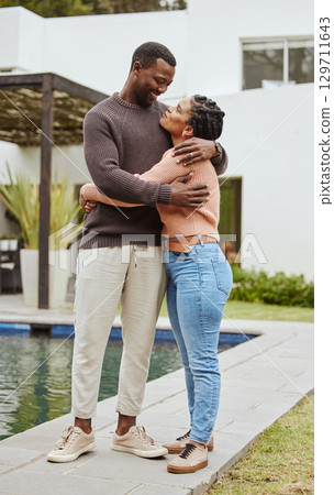 Black couple, house and swimming pool property while outdoor for a hug, love and care while happy about real estate. Man and woman at their new home with pride and smile for mortgage loan approval Black couple, house and swimming pool property while outdoor for a hug, love and care while happy about real estate. Man and woman at their new home with pride and smile for mortgage loan approval 129711643