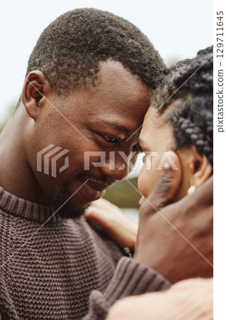 Black couple, forehead and smile for love, embrace or happy relationship bonding together in the outdoors. Black man touching heads and holding woman in romance, support or hug for partnership Black couple, forehead and smile for love, embrace or happy relationship bonding together in the outdoors. Black man touching heads and holding woman in romance, support or hug for partnership 129711645