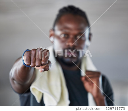 Fist, boxer and martial arts with black man and fitness, sports and boxing with exercise and hand zoom. Athlete, wellness and MMA fighter with towel, workout and training with sport motivation 129711773
