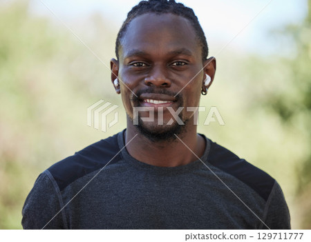Fitness, black man and portrait of happy runner, earphones and training exercise in Nigeria park. Face, smile and sports athlete listening to music for motivation, healthy goals and wellness workout 129711777