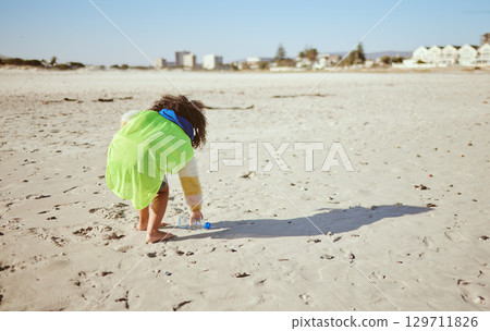 Plastic bottle, beach and child recycling for ocean, earth day or climate change education, learning and volunteer support in nonprofit. Girl recycle, environment and bottle on ground for pollution 129711826